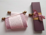 Pink scroll with decorative border, custom text and gold accents, and a burgundy gift box
