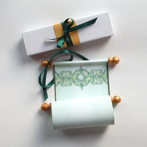 green and gold paper scroll with decorative design and gift box