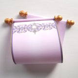 purple and gold paper scroll with decorative design