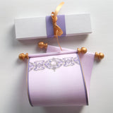 purple and gold paper scroll with box