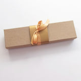 Rustic tan parchment scroll for hand writing with aged gold accents and optional gift box, 5x13" paper