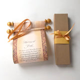 decorative custom printed scroll with gold accents,  and gift box with ribbon.