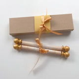 decorative custom printed scroll with gold accents and a gift box