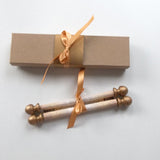 decorative custom printed scroll with gold accents and a gift box