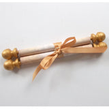 decorative blank scroll with gold accents and brooch