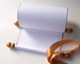 Blank white paper scroll for handwritten wedding vows, gold finials and accents, with white presentation box