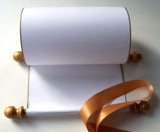 Blank white paper scroll for handwritten wedding vows, gold finials and accents, with white presentation box