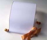Blank white paper scroll for handwritten wedding vows, gold finials and accents, with white presentation box