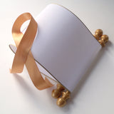 Blank white paper scroll for handwritten wedding vows, gold finials and accents, with white presentation box