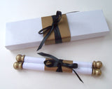 Traditional black and white wedding invitation scroll with aged gold accents and presentation box